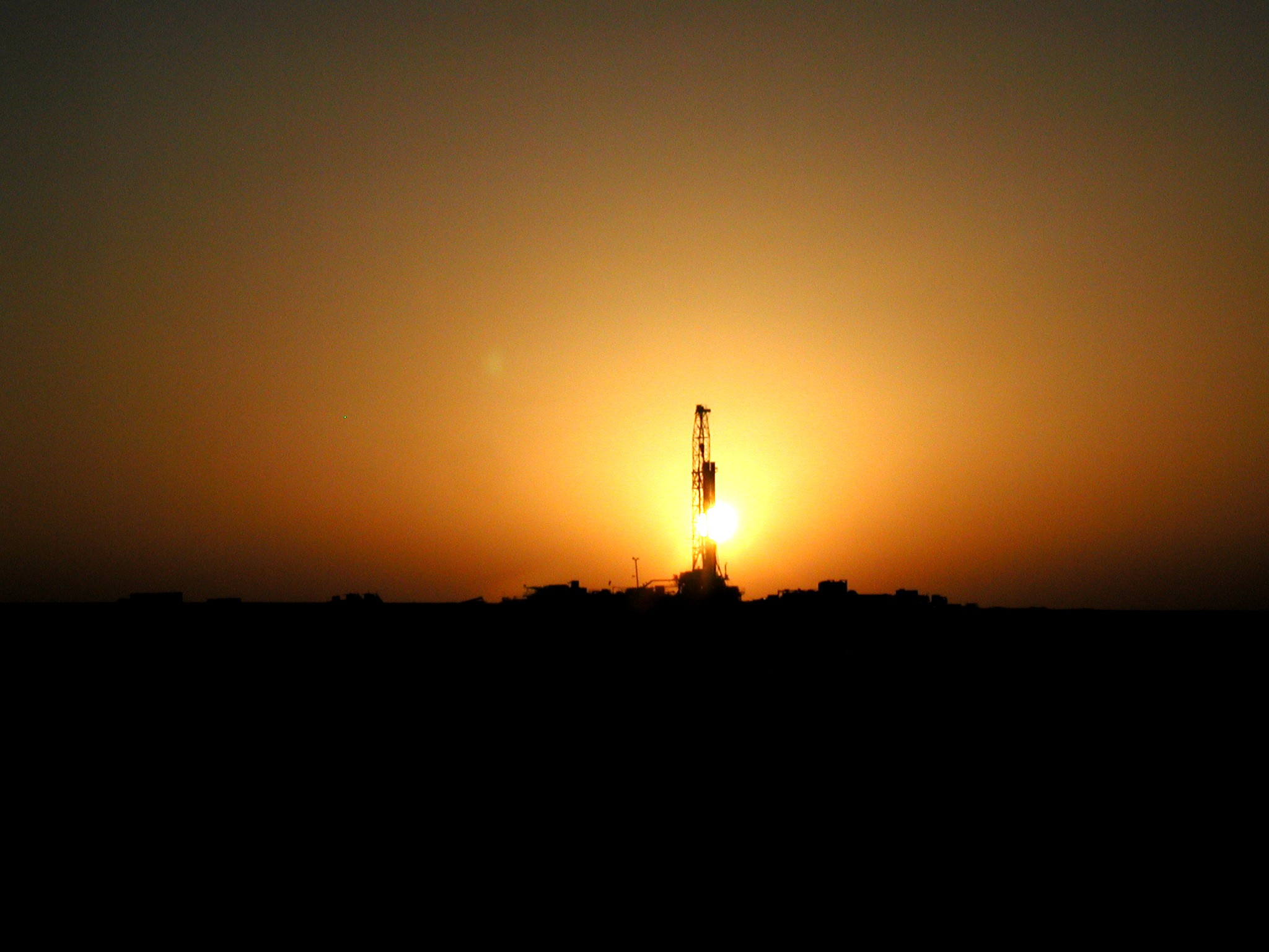 Drilling rig on the background of sunset